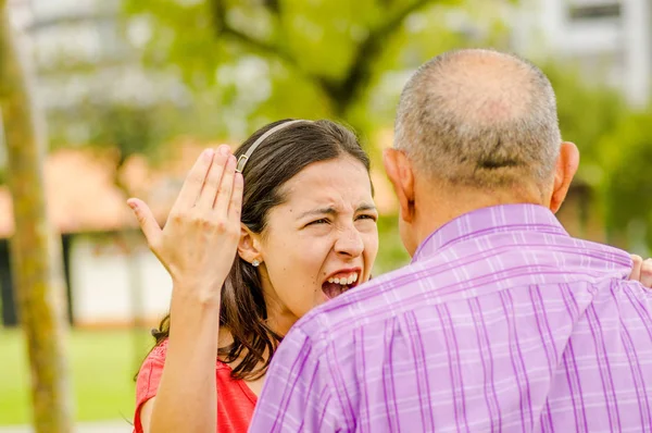 Close up of daughter arguing with his father at outdoors — Stock Photo, Image