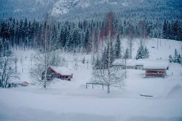 A hagyományos norvég hegyi vörös faházak kültéri nézete, mely hóval borított, lenyűgöző természeti hátteret Norvégiában — Stock Fotó