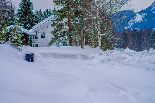 발드레스, 노르웨이 - 2018년 3월 26일: 노르웨이 발드레스 지역의 아름다운 자연 배경에 눈이 내리는 전통적인 목조 백색 가옥의 야외 전망 — 스톡 사진