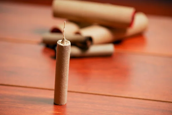 Standing brown firecrackers over a wooden table — Stock Photo, Image