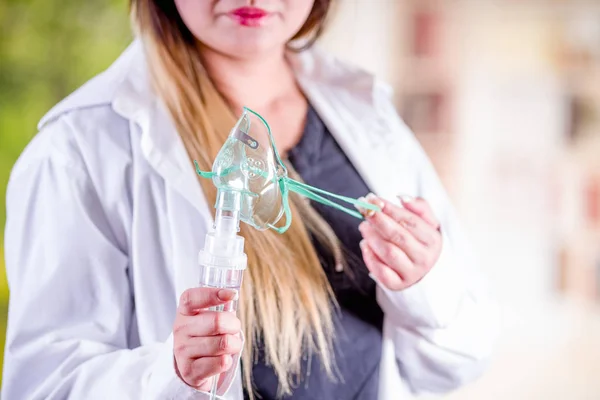 Close up de mulher segurando em suas mãos um nebulizador para asma e doenças respiratórias em casa — Fotografia de Stock