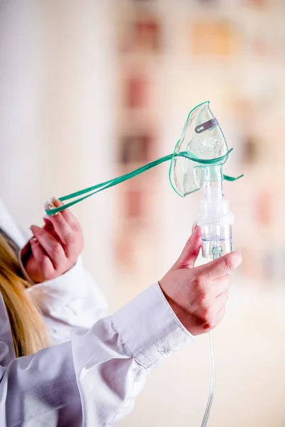 Primer plano de la mujer sosteniendo en sus manos un nebulizador para el asma y las enfermedades respiratorias en el hogar — Foto de Stock