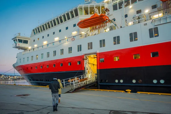 ALESUND, NORWAY - APRIL 06, 2018: View of vessel KONG HARALD with doors opened to put the luggage inside, is a daily passenger and freight shipping service along Norway between Bergen and Kirkenes — Stock Photo, Image