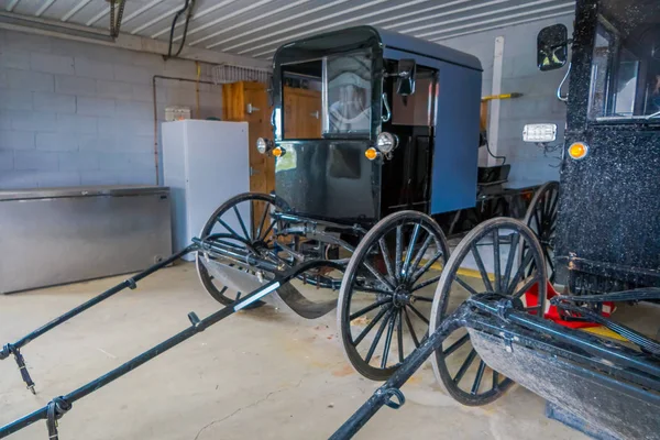 Binnen mening van Amish zwarte vervoer of buggy geparkeerd binnenkant van een garage van een huis in Lancaster County — Stockfoto