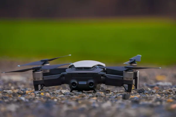 Close up of selective focus of black drone located in an urban road with a blurred background — Stock Photo, Image