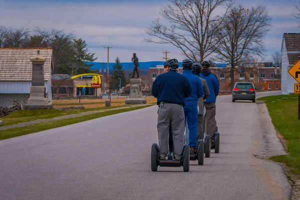 GETTYSBURG, USA - APRIL, 18, 2018: Back view line of tourists on Segways Seg Tours in Gettysburg National Military Park, in a tour on Cemetery battlefield park — Stock Photo, Image