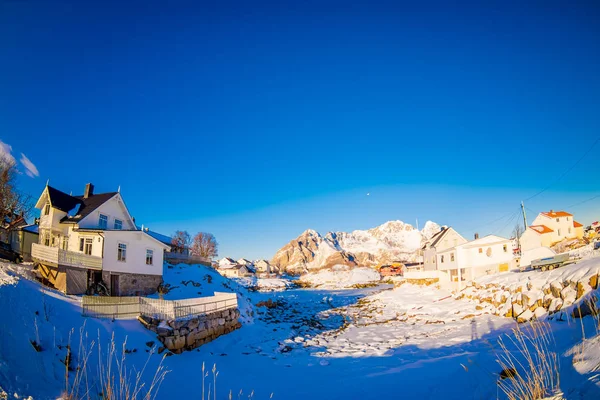 Outdoor view to typical village with wooden houses covered with snow during a winter season in Henningsvaer, Lofoten — Stock Photo, Image