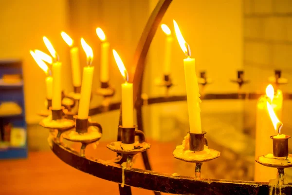 ALESUND, NORWAY - APRIL 04, 2018: Close up of many candles over a metallic chandelier inside of the Bodo cathedral in Nordland county — Stock Photo, Image