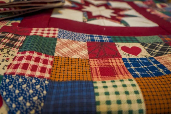 Close up van patroon, zelfgemaakte deken met knappe kleurenschema vervaardigd met behulp van patch werk teqnique geplaatst op het meubilair — Stockfoto
