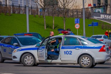 Moskova, Rusya - Nisan, 24, 2018: kırmızı kare üzerinde güneşli bir günde, Moskova Rusya'da bir polis araba içinde kimliği belirsiz adam açık görünümü