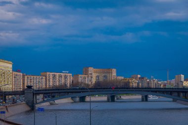 Outdoor panoramic view of Moscow and bridge over the Moskva River in conecting modern skyscrapers of Moscow-City. Landscape and cityscape of Moscow in cloudy sky clipart