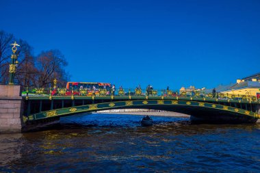 St Petersburg, Rusya, 02 Mayıs 2018: açık mavi gökyüzü ile güzel bir güneşli gün St. Petersburg Moika Nehri boyunca yeşil köprü altında bir yat geçerken insanlarda görünümünü