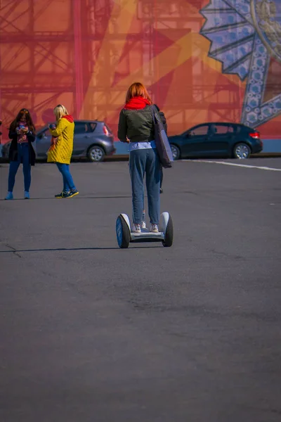 ST. PETERSBURG, RUSSIA, 02 MAY 2018: Outdoor view of unidentified woman using a segway in the streets of the city of St. Petersburg — стоковое фото