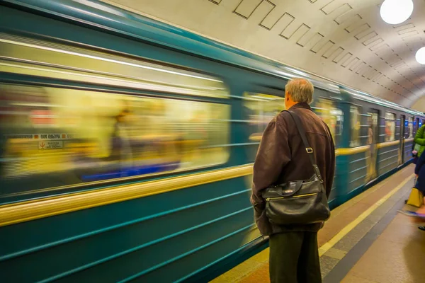MOSCÚ, RUSIA - 24 DE ABRIL DE 2018: Un hombre no identificado espera un tren en la estación de metro en la que viaja expreso con pasajeros, metro, Moscú —  Fotos de Stock