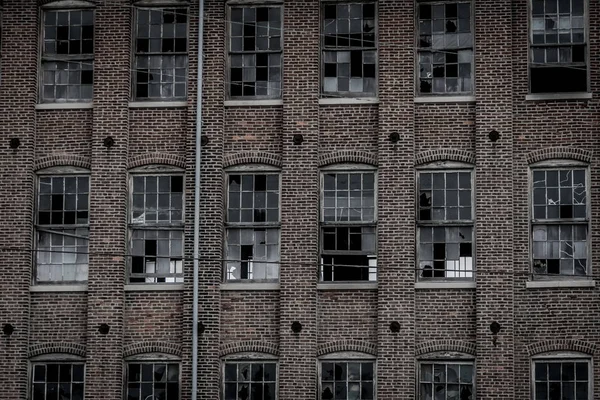 Outdoor view of rusted old building with detroyed windows, brick wall building, located in the city of Lancaster