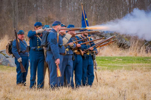 MOORPARK, USA - APRIL, 18, 2018: Group of people wearing uniform and representing the military war reenactment in Moorpark, firing their guns, is the largest battle reenactment west — Stock Photo, Image