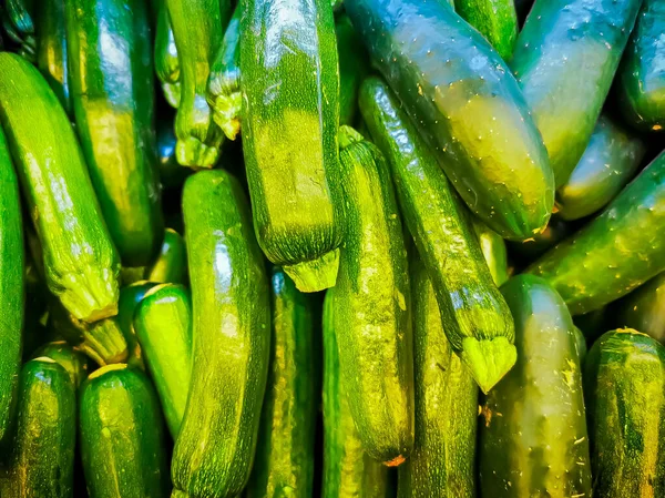 Högen av färska gurkor ovanifrån, grön bakgrund. — Stockfoto