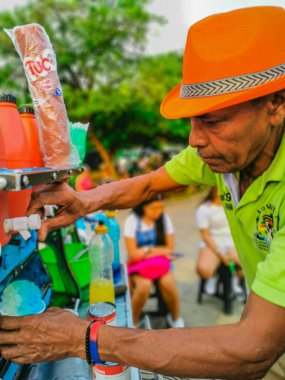 CARTAGENA, COLOMBIA - NOVEMBER 12, 2019: Ice cream Street vendors at the Streets of the Getsemani neighborhood of Cartagena, Colombia clipart