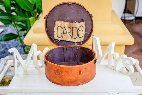 Runde braune Lederschatulle für Karten, an den Seiten weiße Holzwörter mr und mrs. Hochzeitsrequisiten. — Stockfoto