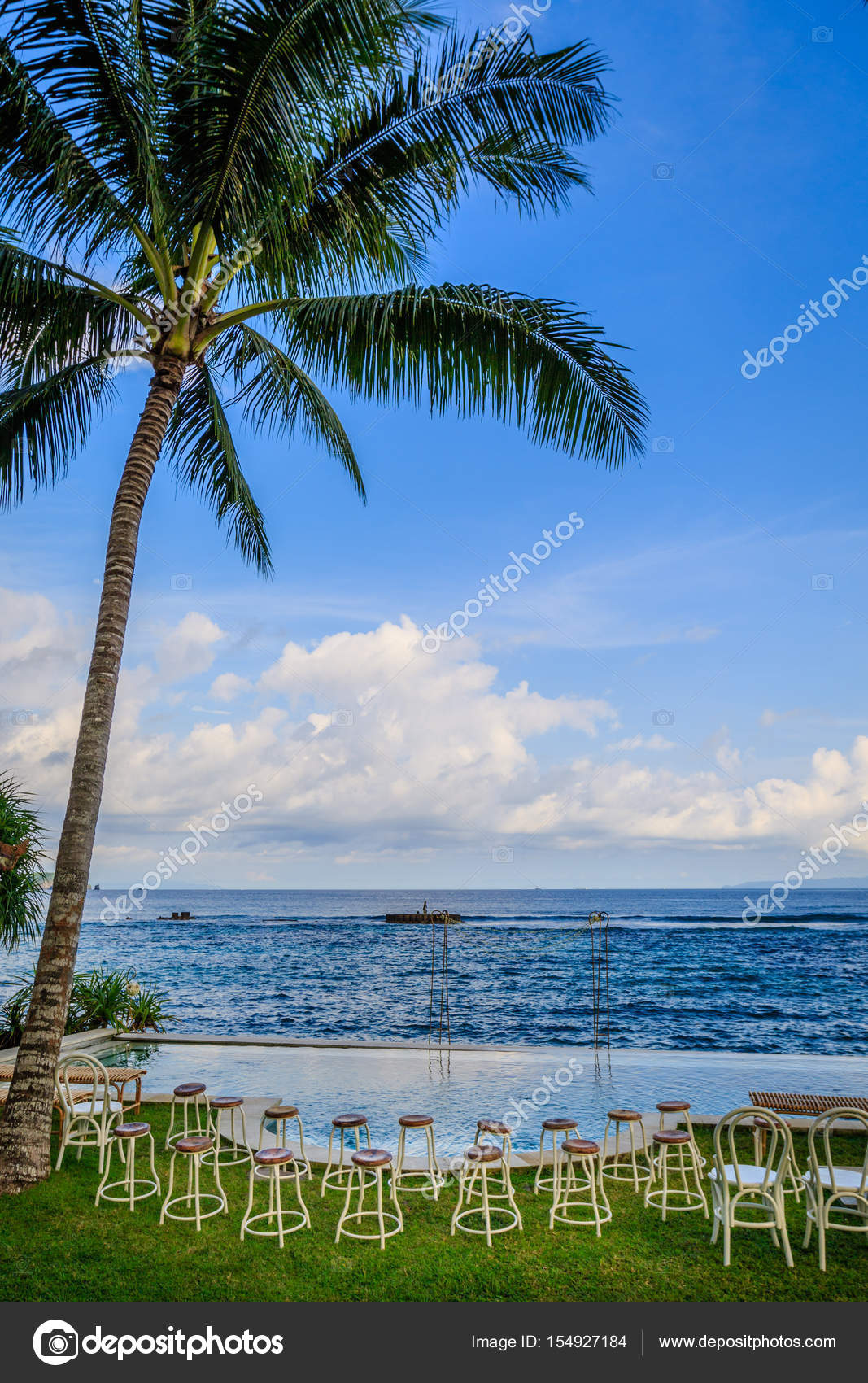 Wedding ceremony setup near the ocean at sunset - stools for