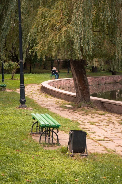 Bancos de resto no Parque de cidade em um contexto de lago — Fotografia de Stock