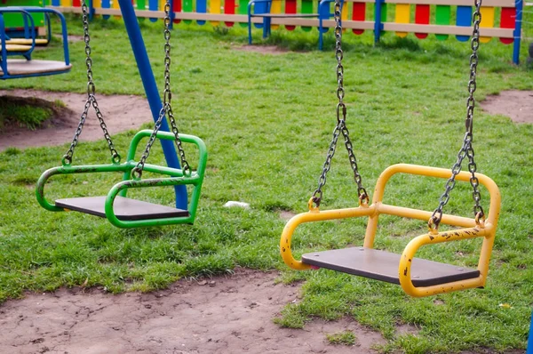 Columpios de colores brillantes en el parque infantil  . —  Fotos de Stock