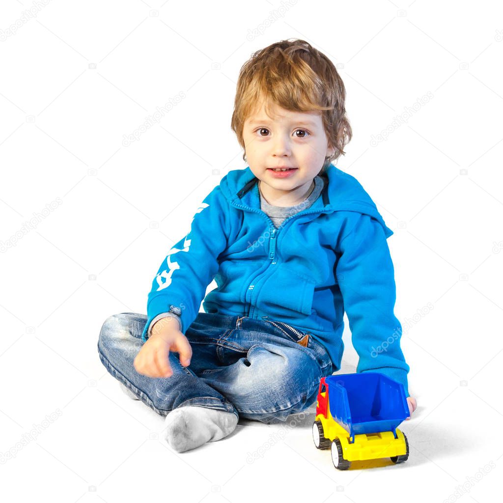 child boy playing with toys isolated on white