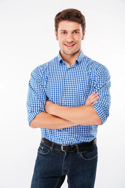 Happy confident young man standing with arms crossed — Stock Photo, Image