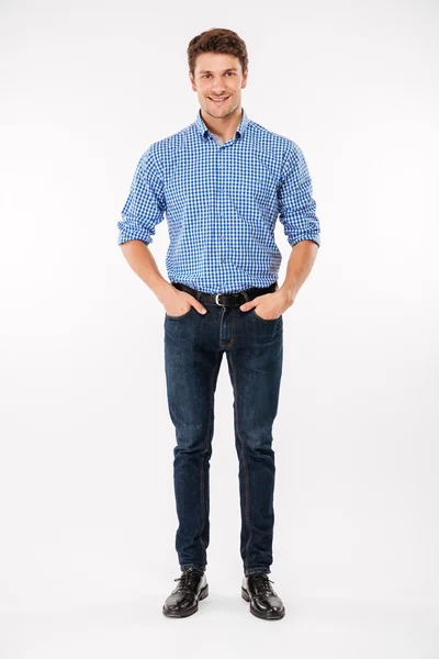 Full length of handsome smiling young man standing — Stock Photo, Image