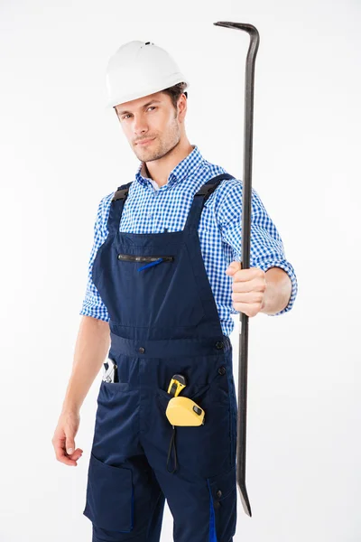 Serious male builder holding crowbar — Stock Photo, Image
