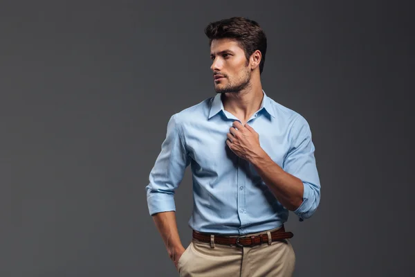 Portrait of a casualman buttoning his shirt isolated — Stock Photo, Image