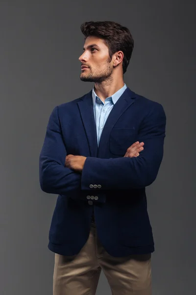 Serious handsome man with arms folded standing — Stock Photo, Image