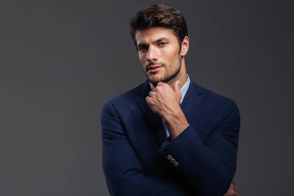 Thoughtful young brunette man in blue jacket thinking about something — Stock Photo, Image