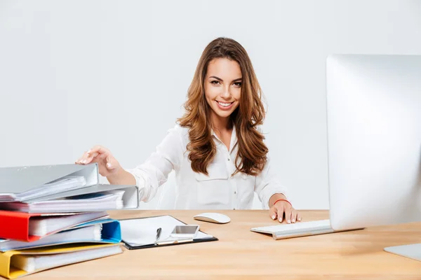 Sonriente mujer de negocios alegre sentada en su lugar de trabajo — Foto de Stock