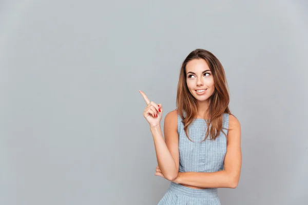 Glücklich schöne junge Frau zeigt weg — Stockfoto