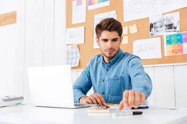 Affärsman som arbetar med laptop på kontoret och ta pennan — Stockfoto