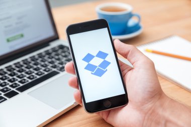 Man holding iphone 6 showing Dropbox app clipart