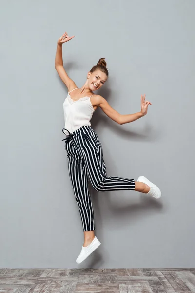 Retrato de comprimento total de uma mulher bonita alegre saltando — Fotografia de Stock
