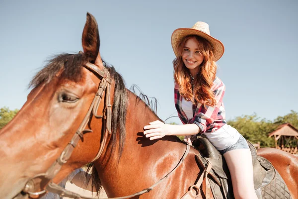 Happy pretty young woman cowgirl riding horse — Stock Photo, Image