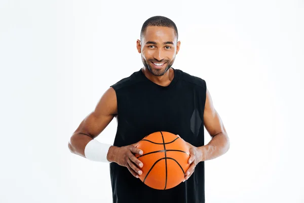 Happy african basketball player standing with ball — Stock Photo, Image