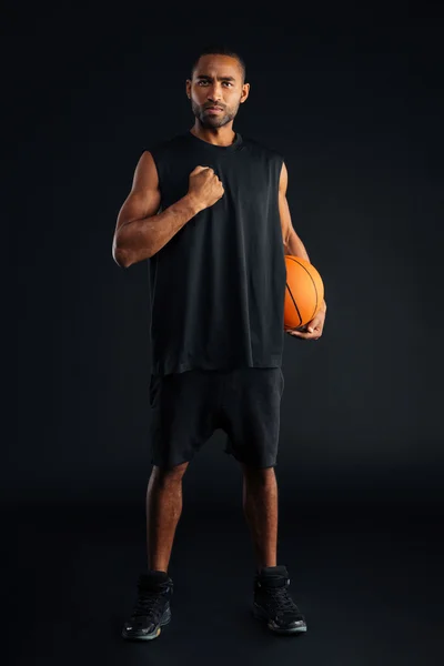 Sports man with basket ball holding hand on his chest — Stock Photo, Image