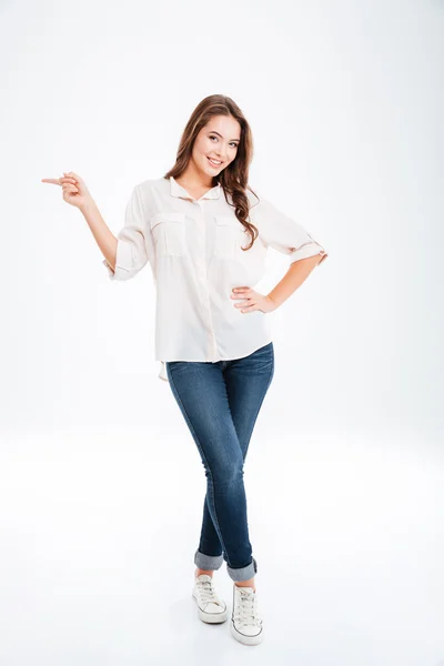 Retrato de comprimento total de uma mulher feliz apontando dedo para longe — Fotografia de Stock