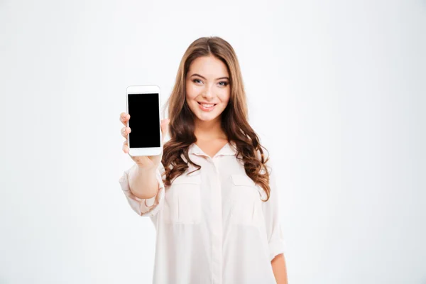 Smiling woman showing blank smartphone screen isolated on white background — Stock Photo, Image