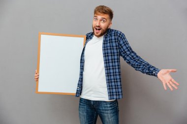 Neşeli sakallı adam boş tahta tutan ve omuz silkme