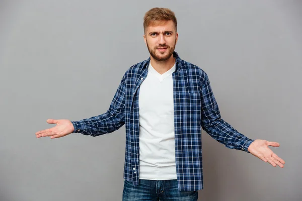 Portrait of a bearded casual man shrugging shoulders — Stock Photo, Image