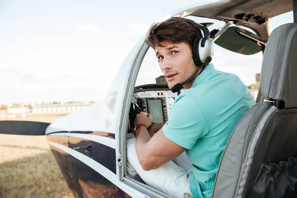 Man pilot sitting in cabin of small airplane — Stock Photo, Image