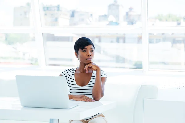 Retrato de uma mulher de negócios pensativa séria usando laptop no escritório — Fotografia de Stock