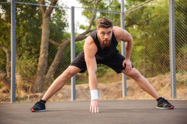Koşu önce ısınma ve germe kendine güvenen genç erkek atlet