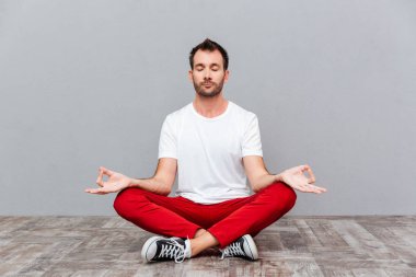 Man in casual cloth sitting in lotus position clipart