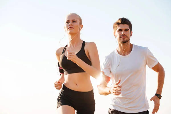 Pareja joven corredores entrenando al aire libre — Foto de Stock